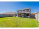 Expansive backyard with green grass and a covered patio, as seen from the yard at 12801 W Sweetwater Ave, El Mirage, AZ 85335
