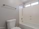 Bright bathroom with a tub and shower combination and neutral fixtures at 12801 W Sweetwater Ave, El Mirage, AZ 85335