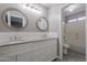 Bathroom featuring double vanity with granite counters and white subway tile at 12801 W Sweetwater Ave, El Mirage, AZ 85335