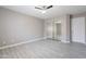 Bedroom featuring wood-look tile, mirrored closet doors, and ceiling fan at 12801 W Sweetwater Ave, El Mirage, AZ 85335