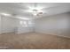 Large bedroom featuring neutral walls, carpet, a ceiling fan, and a half wall at 12801 W Sweetwater Ave, El Mirage, AZ 85335