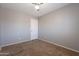 Bedroom with neutral walls, carpet, a ceiling fan, and a white door at 12801 W Sweetwater Ave, El Mirage, AZ 85335