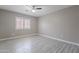 Bedroom featuring wood-look tile floor, neutral paint and window with shutters at 12801 W Sweetwater Ave, El Mirage, AZ 85335
