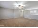 Large bedroom featuring neutral walls, carpet, a ceiling fan, and a hallway at 12801 W Sweetwater Ave, El Mirage, AZ 85335