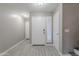 Bright foyer with white doors, tile flooring, neutral paint and access to the stairway at 12801 W Sweetwater Ave, El Mirage, AZ 85335