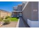 Attractive home facade with a desert landscape, walkway, and white front door at 12801 W Sweetwater Ave, El Mirage, AZ 85335