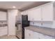Updated kitchen featuring stainless steel appliances, granite counters, and white cabinets at 12801 W Sweetwater Ave, El Mirage, AZ 85335