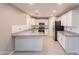 Well-lit kitchen with white cabinets, stainless steel appliances and granite countertops at 12801 W Sweetwater Ave, El Mirage, AZ 85335