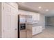 A stainless steel refrigerator complements the shaker cabinets and granite counters in this well-lit kitchen at 12801 W Sweetwater Ave, El Mirage, AZ 85335
