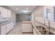 Modern kitchen with stainless steel appliances, white cabinets, granite countertops, and an open view at 12801 W Sweetwater Ave, El Mirage, AZ 85335
