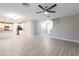 Spacious open-concept living room with neutral color palette and a seamless flow into the modern kitchen at 12801 W Sweetwater Ave, El Mirage, AZ 85335