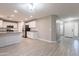 Open concept kitchen and living area, featuring white cabinets, stainless appliances and tile floors at 12801 W Sweetwater Ave, El Mirage, AZ 85335