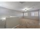 Upstairs loft with neutral carpet, paint, and natural light from windows at 12801 W Sweetwater Ave, El Mirage, AZ 85335