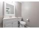 Powder room with white vanity and fixtures and neutral wall color at 12801 W Sweetwater Ave, El Mirage, AZ 85335