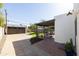 Expansive backyard featuring a covered patio, garage, mature trees, and lush green lawn, perfect for outdoor living at 1309 W Lynwood St, Phoenix, AZ 85007