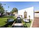 Beautiful backyard featuring a fire pit with chairs and a well-maintained lawn at 1309 W Lynwood St, Phoenix, AZ 85007