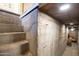 Unfinished basement stairs showing the concrete wall and basic construction at 1309 W Lynwood St, Phoenix, AZ 85007