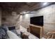 Relaxing basement featuring a comfortable seating area, entertainment center, and modern design at 1309 W Lynwood St, Phoenix, AZ 85007