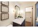 Stylish bathroom with a framed mirror, sconces, vanity, and decorative wall art at 1309 W Lynwood St, Phoenix, AZ 85007