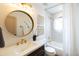Elegant bathroom featuring a round mirror, modern vanity, and shower-tub combination with white tile at 1309 W Lynwood St, Phoenix, AZ 85007