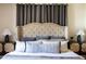 Bedroom with gray curtains, stylish decor and accents, and a large decorative headboard at 1309 W Lynwood St, Phoenix, AZ 85007