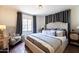 Comfortable bedroom featuring gray curtains and tiled floors at 1309 W Lynwood St, Phoenix, AZ 85007