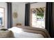 Bedroom features an open window, decorative accents and neutral color scheme at 1309 W Lynwood St, Phoenix, AZ 85007