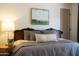 Bedroom with a paneled headboard, decorative throw pillows, and landscape wall art at 1309 W Lynwood St, Phoenix, AZ 85007