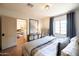 Bedroom with stylish decor, tiled floors, and an open doorway into a connecting room at 1309 W Lynwood St, Phoenix, AZ 85007