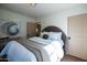 Well-lit bedroom boasts a comfortable bed, stylish decor, and tiled floors at 1309 W Lynwood St, Phoenix, AZ 85007