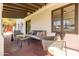 Relaxing covered porch with comfortable seating, exposed beam ceiling, and stylish outdoor decor at 1309 W Lynwood St, Phoenix, AZ 85007