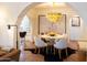 Elegant dining area with a modern chandelier, round table, and stylish seating for four at 1309 W Lynwood St, Phoenix, AZ 85007