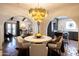 Dining room showcasing a bright chandelier, seating for four, and easy access to kitchen at 1309 W Lynwood St, Phoenix, AZ 85007