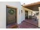 Close up of home's entry, showcasing decorative front door, porch seating and address numbers at 1309 W Lynwood St, Phoenix, AZ 85007