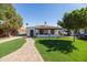 Inviting single-story home with a red-tiled roof, and a neatly landscaped yard at 1309 W Lynwood St, Phoenix, AZ 85007