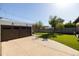 Two-car garage next to a lush green lawn, mature trees, and a private backyard, creating a serene outdoor space at 1309 W Lynwood St, Phoenix, AZ 85007
