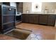 Gourmet kitchen features sleek cabinetry, stainless steel appliances, and adjacent hidden cellar access at 1309 W Lynwood St, Phoenix, AZ 85007
