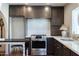 Chef's kitchen with gas range, white countertops, and modern appliances at 1309 W Lynwood St, Phoenix, AZ 85007