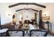 Open living room showcasing wood beam ceilings, a fireplace, and classic, yet comfortable seating at 1309 W Lynwood St, Phoenix, AZ 85007