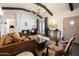Spacious living room featuring a cozy fireplace, exposed beam ceiling, stylish decor, and elegant furnishings at 1309 W Lynwood St, Phoenix, AZ 85007