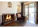 Cozy living room featuring a tiled fireplace, with neutral decor and an open doorway at 1309 W Lynwood St, Phoenix, AZ 85007