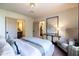 Bright main bedroom featuring an ensuite bath, stylish decor, and terra cotta tile flooring at 1309 W Lynwood St, Phoenix, AZ 85007
