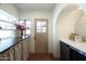 Charming mudroom with built-in shelving, natural light, stylish tile flooring, and exterior access at 1309 W Lynwood St, Phoenix, AZ 85007