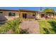 Attractive backyard featuring rock landscaping, healthy green grass, and a covered patio at 131 N Higley Rd # 41, Mesa, AZ 85205