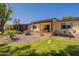 Beautiful backyard featuring a covered patio, gravel landscaping, and green grass at 131 N Higley Rd # 41, Mesa, AZ 85205