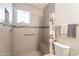 Updated bathroom features tiled shower with seat and grab bar for safety at 131 N Higley Rd # 41, Mesa, AZ 85205