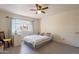 Cozy bedroom featuring a ceiling fan, neutral walls, and a window with plenty of natural light at 131 N Higley Rd # 41, Mesa, AZ 85205