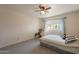 Bright bedroom with neutral walls and tile flooring, featuring a ceiling fan and a window at 131 N Higley Rd # 41, Mesa, AZ 85205