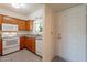 Cozy kitchen featuring granite countertops, tile floors, and white appliances at 131 N Higley Rd # 41, Mesa, AZ 85205