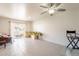 Bright and airy living room with tile flooring, ceiling fan and sliding glass doors at 131 N Higley Rd # 41, Mesa, AZ 85205